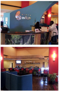 a hotel reception area with a couple of people