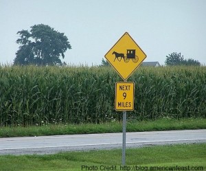 a yellow sign on the side of a road