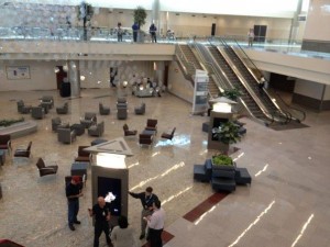 a large lobby with escalators and people