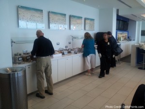 people standing in a line at a buffet