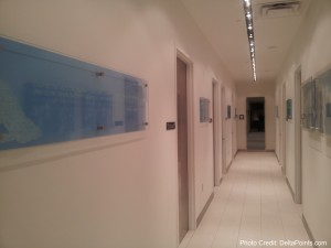 a long hallway with white walls and a sign on the wall