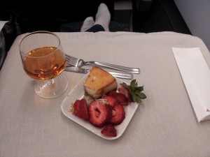 a plate of fruit and a glass of wine