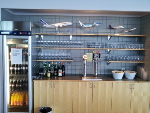 a bar with shelves and glasses