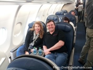 a man and woman sitting on an airplane