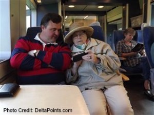a man and woman sitting on a train