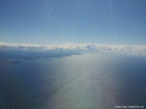 a blue sky with clouds above water