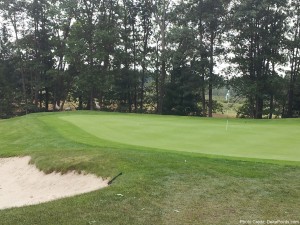 a golf course with a sand trap