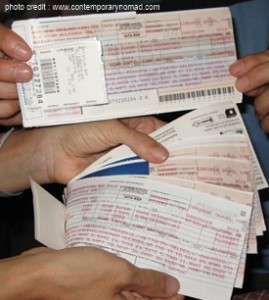 several hands holding several tickets