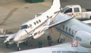 a white airplane parked at an airport