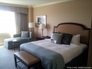 a bedroom with a bed and a chair