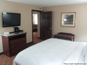 a bedroom with a bed and a television