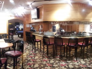 a bar with chairs and a counter