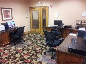 a room with a computer and desks