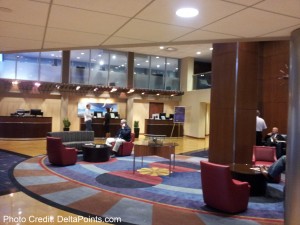 a lobby with a round area rug and chairs