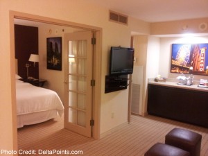 a bedroom with a tv and a television