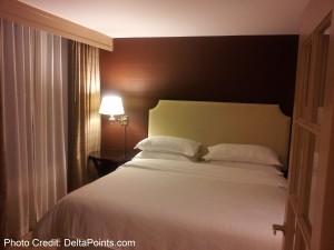 a bed with pillows and a lamp