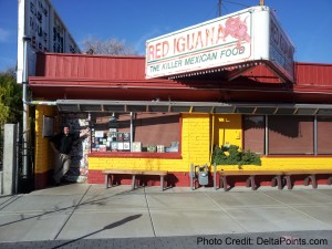 a man standing in front of a restaurant