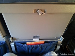 an open seat with a blue bag inside