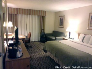 a hotel room with a bed and a desk