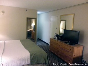 a bedroom with a television and a dresser