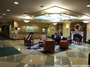 a lobby with chairs and a fireplace