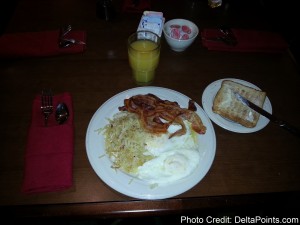 a plate of food and a glass of juice
