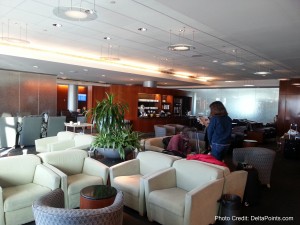 a room with white chairs and a plant