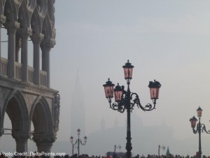 a street lamp with a group of people walking