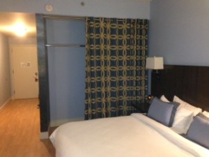 a bed with a white bedding and a lamp