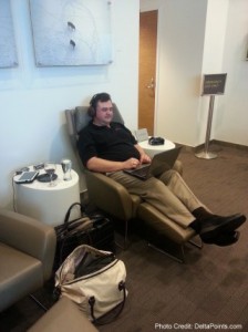 a man sitting in a chair with a laptop
