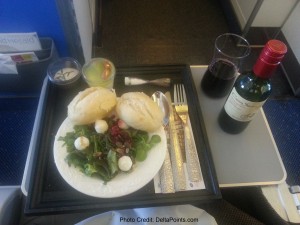 a plate of salad and bread on a tray