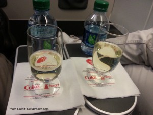a couple of glasses of liquid and a bottle of water