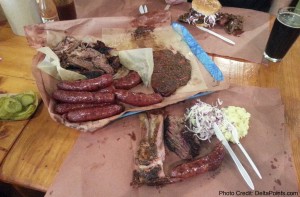 a plate of meat and sausages on a table