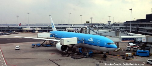 a blue and white airplane at an airport