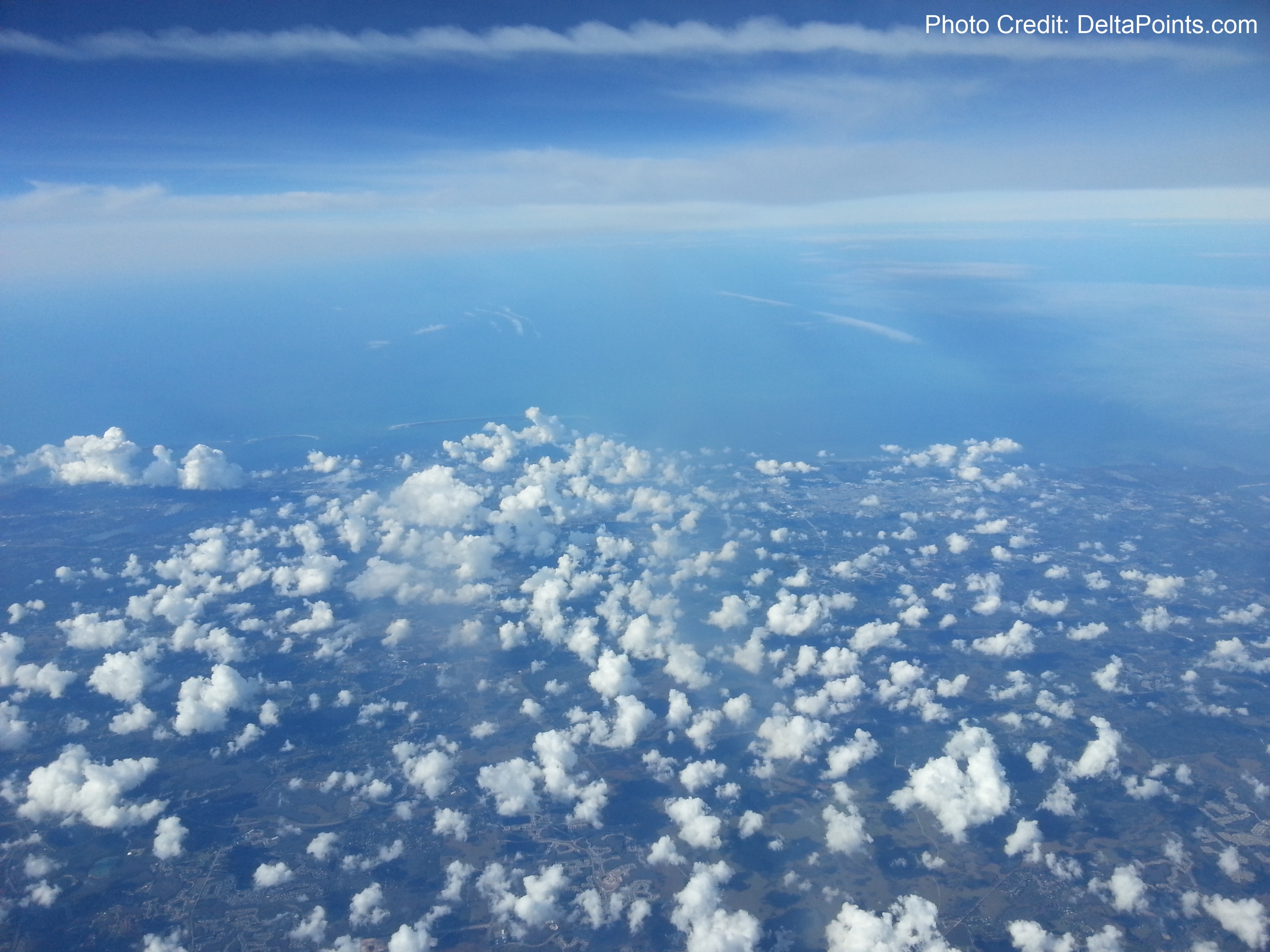 aerial view of clouds and land from an airplane