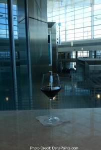 a glass of red wine centurion lounge delta points review