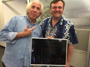 two men standing next to each other holding a sign