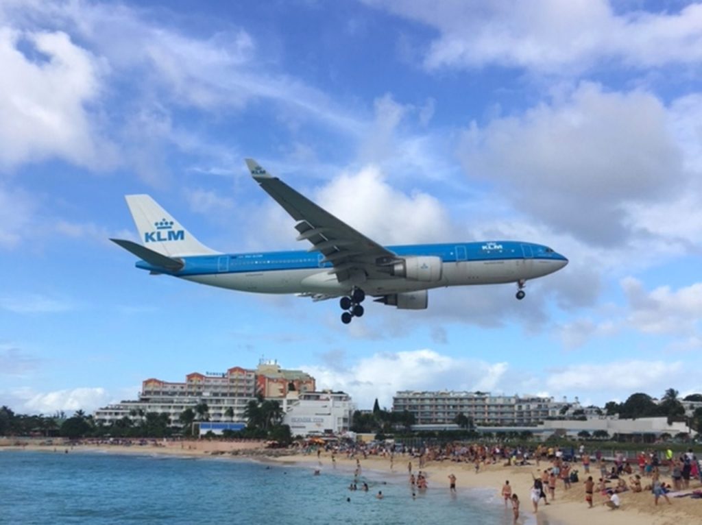 a plane flying over a beach