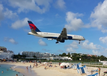 a plane flying over a beach