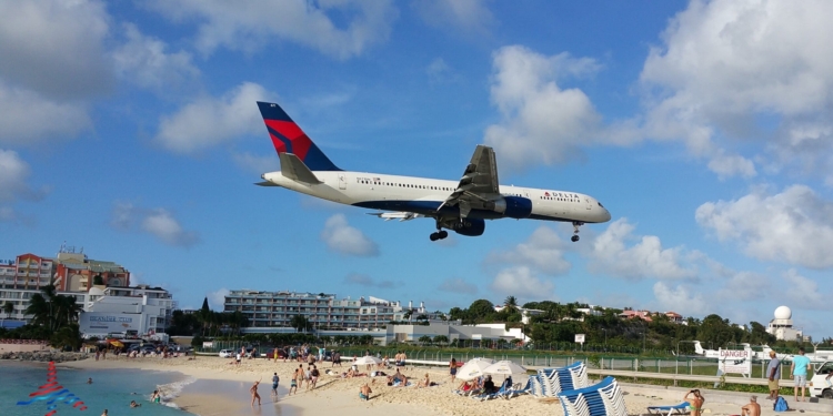 a plane flying over a beach