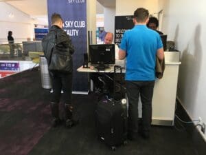 a group of people standing in front of a computer