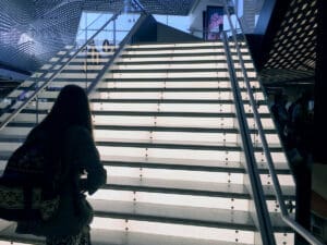 a woman walking up a set of stairs