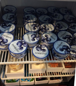 a shelf with blue and white containers