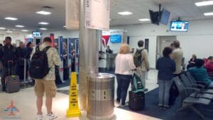 people standing in a line at an airport