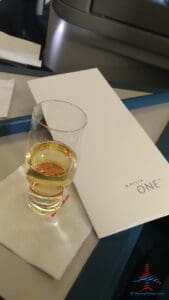 a glass of liquid on a white surface