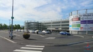 a parking lot with cars in front of a building