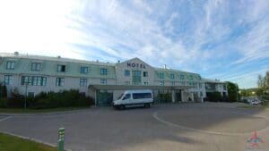 a white van parked outside of a hotel