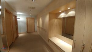 a hallway with a mirror and a door