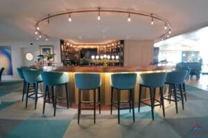 a bar with blue chairs and a round counter