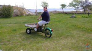 a man riding a small tricycle